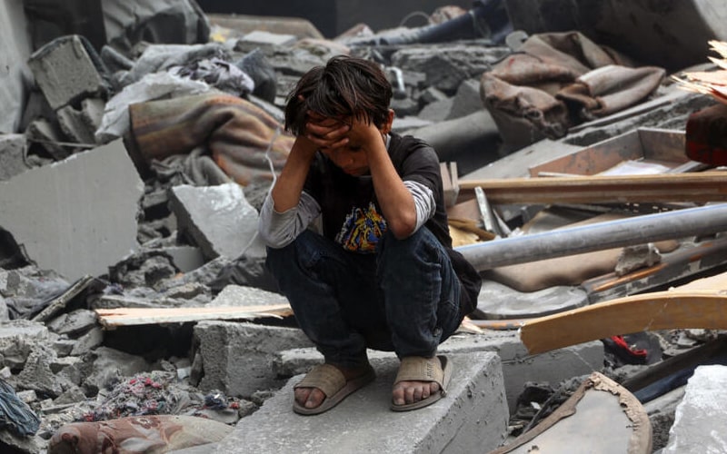 Aftermath of Israeli airstrike in Gaza City showing destroyed buildings and emergency responders.