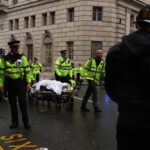 Emergency services attend the scene of the Liverpool parade crash as fans watch in shock