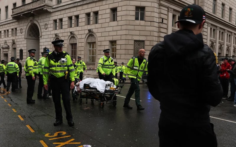 Emergency services attend the scene of the Liverpool parade crash as fans watch in shock